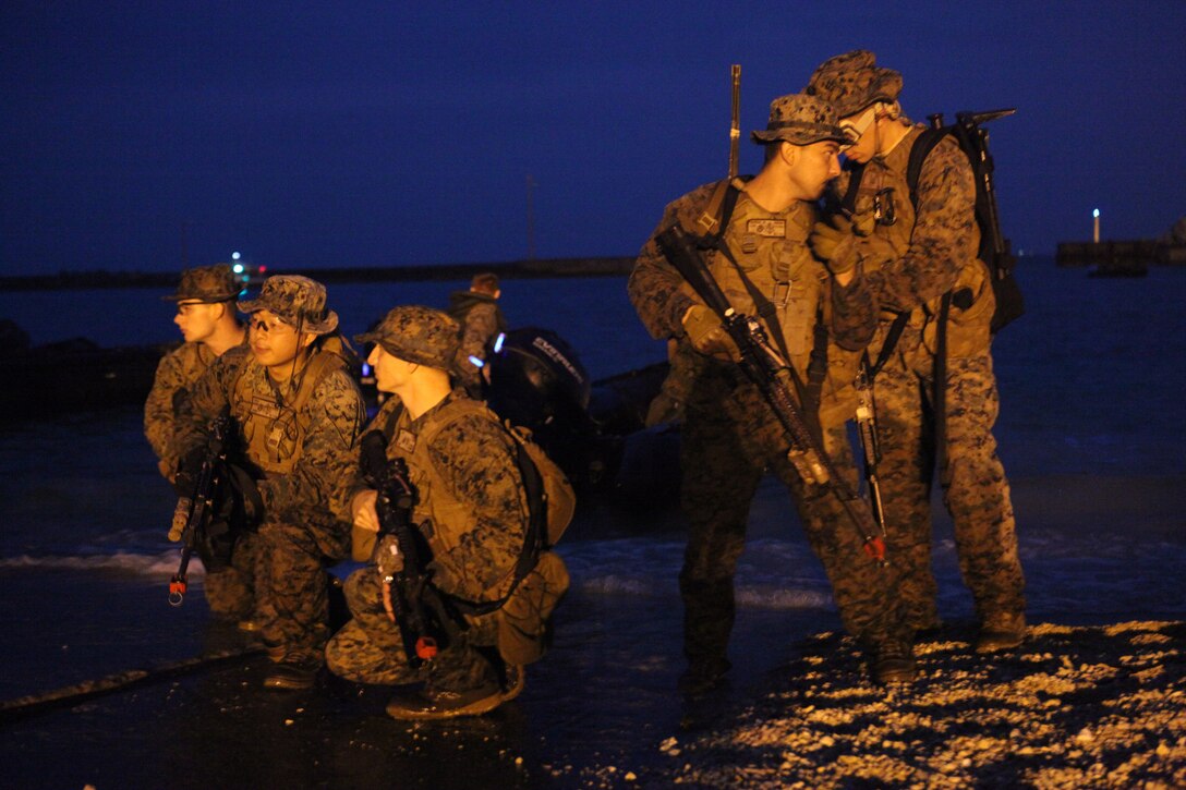 Marines with Company A, Battalion Landing Team 1st Battalion, 4th Marines, 31st Marine Expeditionary Unit, await orders to assault further inland during a small boat raid here, March 17. The raid was conducted during the MEU’s Certification Exercise, which upon completion certifies that the MEU is capable to respond to any scenario that may arise. The 31st MEU is the only continuously forward-deployed MEU and is the nation’s force in readiness in the Asia-Pacific region.