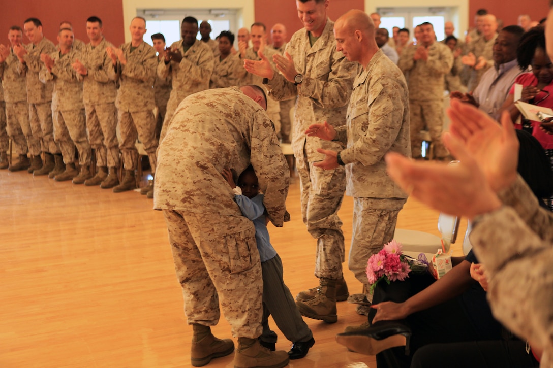 Sgt. Maj. Herbert Wayne Wrench, the sergeant major of 2nd Marine Logistics Group, receives a hug from his three-year-old grandson, Isaiah, during his retirement ceremony aboard Camp Lejeune, N.C., March 16, 2012.  Wrench’s wife Jo Ann and daughter Ashley were in attendance, along with dozens of active duty and retired servicemembers whom Wrench became close with during his 30-year career.  (U.S. Marine Corps photo by Cpl. Katherine M. Solano)