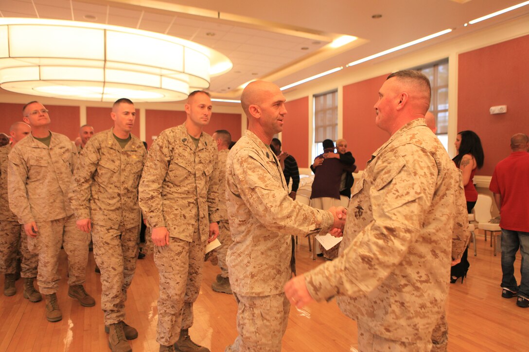 Sgt. Maj. Herbert Wayne Wrench (right), the sergeant major of 2nd Marine Logistics Group, is congratulated by a long line of friends and family after his retirement ceremony aboard Camp Lejeune, N.C., March 16, 2012.  During the ceremony, Wrench spoke of the priceless support and love he and his family received throughout his 30-year career.  (U.S. Marine Corps photo by Cpl. Katherine M. Solano)