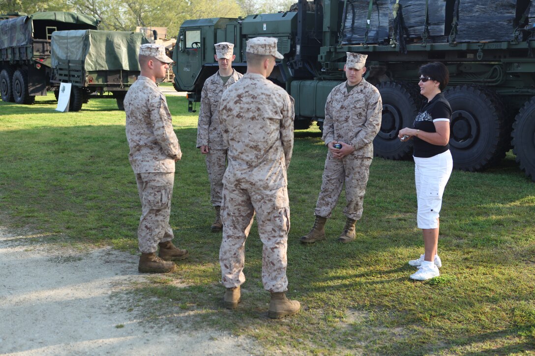 Marines with Combat Logistics Battalion 8, 2nd Marine Logistics Group speak to a visitor during a static display at Patriots Point Naval and Maritime Museum, Charleston Harbor, S.C., March 16, 2012.  The troops had a chance to talk to visitors about some of the vehicles they drive, which included Logistics Vehicle System Replacements, Medium Tactical Vehicle Replacements, Mine Resistance Ambush Protected All-Terrain Vehicles and High Mobility Multipurpose Wheeled Vehicles. (Photo by Cpl. Bruno J. Bego)