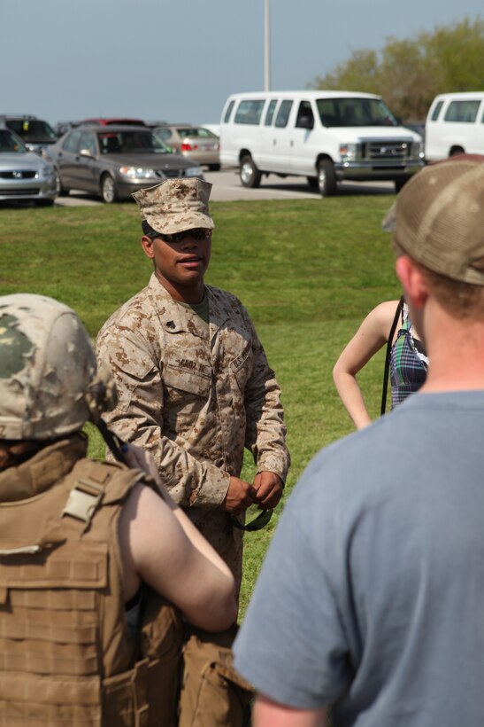 Sgt. Jose A. Cruz Jr., a motor vehicle operator with Combat Logistics Battalion 8, 2nd Marine Logistics Group, speaks to visitors during a static display at Patriots Point Naval and Maritime Museum, Charleston Harbor, S.C., March 16, 2012. The troops had a chance to talk to visitors about some of the vehicles they drive, which included Logistics Vehicle System Replacements, Medium Tactical Vehicle Replacements, Mine Resistance Ambush Protected All-Terrain Vehicles and High Mobility Multipurpose Wheeled Vehicles. (Photo by Cpl. Bruno J. Bego)