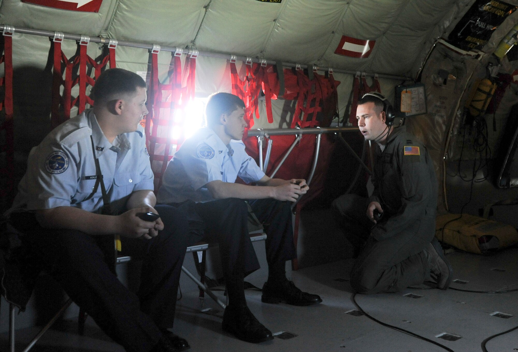 Damien Ackley and Joshua Parker, East High School Air Force Junior ROTC cadets, talk with Capt. Dick Durstein, 22nd Operations Group chief of plans about different functions of the KC-135 Stratotanker during an incentive flight March 15, 2012, McConnell Air Force Base, Kan. More than 50 cadets from four Wichta, Kan., high schools came to McConnell to witness the air refueling mission. (U.S. Air Force photo/ Airman 1st Class Laura L. Valentine)