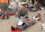 Staff Sgt. Jaime Ralls-Johnson, medical technician, 59th Medical Operations Squadron, evaluates a patient’s injuries during the mass casualty exercise at Joint Base San Antonio-Lackland March 7. The exercise was one phase of the Air Education and Training Command’s Compliance Inspection held here March 5-12. (U.S. Air Force photo/Robbin Cresswell)