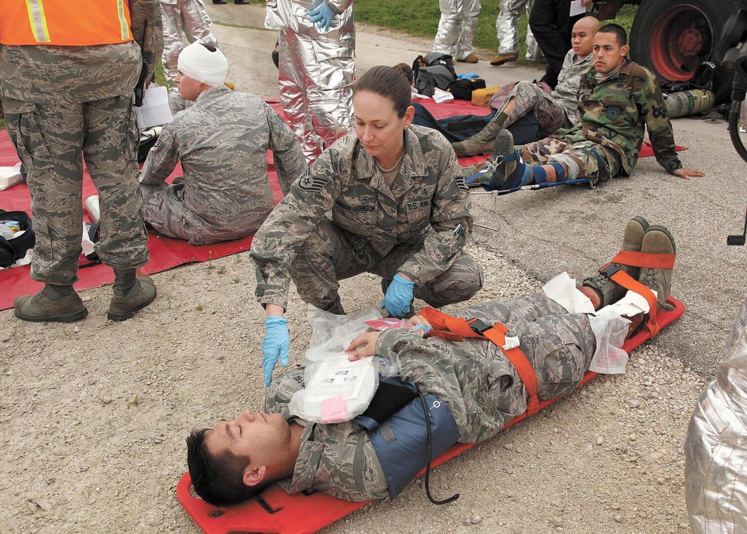 Staff Sgt. Jaime Ralls-Johnson, medical technician, 59th Medical Operations Squadron, evaluates a patient’s injuries during the mass casualty exercise at Joint Base San Antonio-Lackland March 7. The exercise was one phase of the Air Education and Training Command’s Compliance Inspection held here March 5-12. (U.S. Air Force photo/Robbin Cresswell)