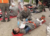 Staff Sgt. Jaime Ralls-Johnson, medical technician, 59th Medical Operations Squadron, evaluates a patient’s injuries during the mass casualty exercise at Joint Base San Antonio-Lackland March 7. The exercise was one phase of the Air Education and Training Command’s Compliance Inspection held here March 5-12. (U.S. Air Force photo/Robbin Cresswell)