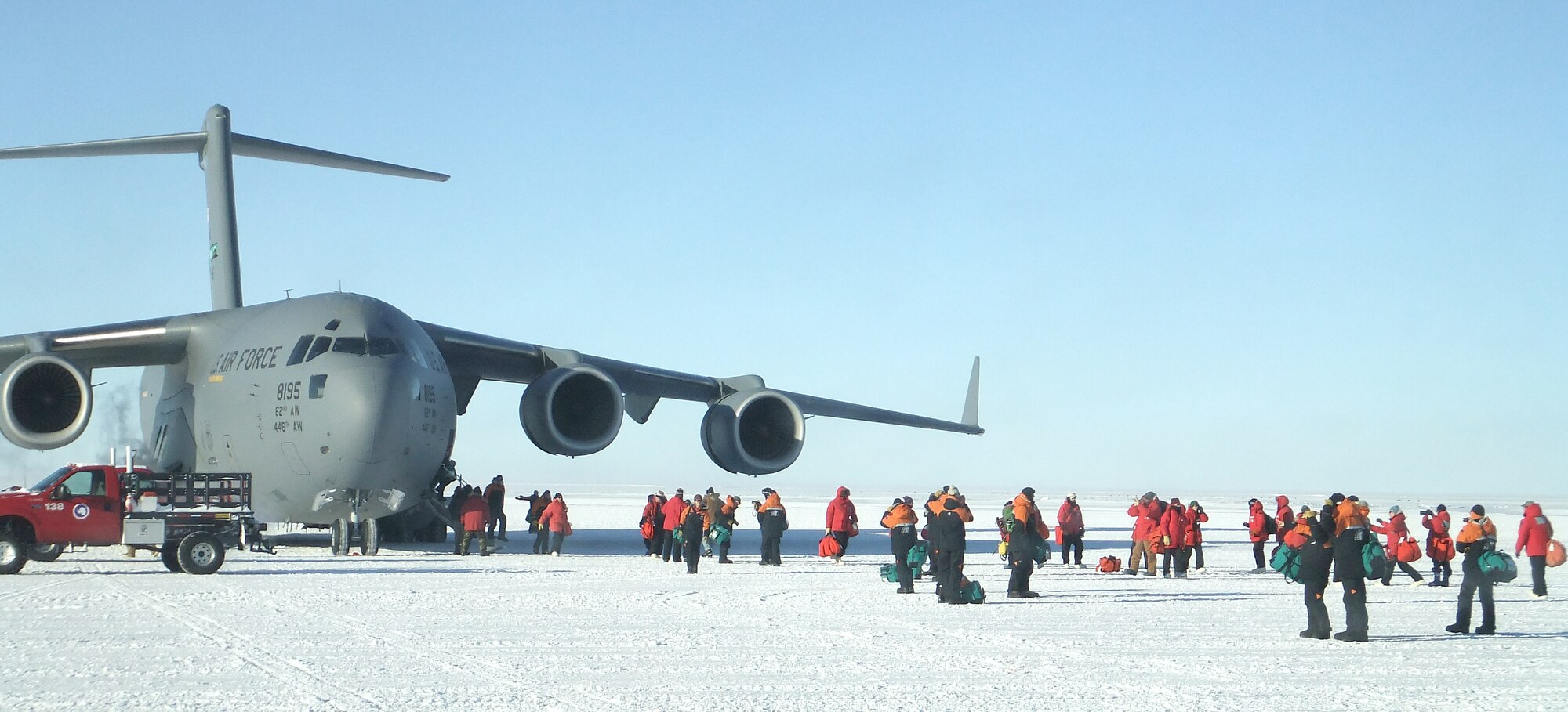 Passengers disembark from an Air Force C-17 Globemaster III at the Annual Sea Ice Runway near McMurdo Station, Antarctica. The C-17 is operated by the men and women of 446th and 62nd Airlift Wings, Joint Base Lewis-McChord, Wash. The first main body flights of the 2011-2012 austral summer season arrived at McMurdo on Oct. 4, 2011. (National Science Foundation photo by Jean Varner)