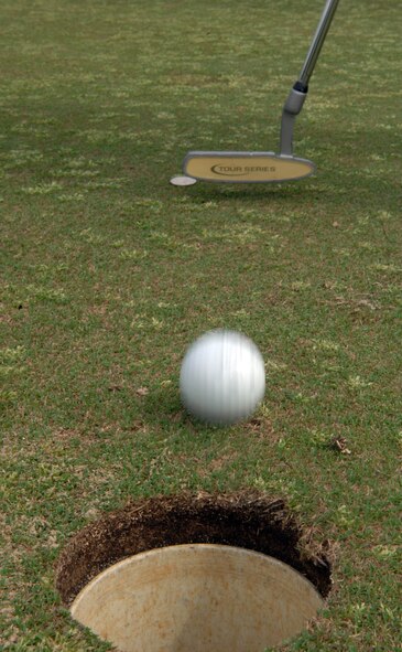Kye Quesinberry, wife of Lt. Col. Milo Quesinberry, 2nd Mission Support Group, putts for par at the Fox Run golf course on Barksdale Air Force Base, La. March 16. Kye Quesinberry played to help the Barksdale Officer's Spouses Club raise money for base organizations, scholarships and the off-base community. (U.S. Air Force photo/Airman 1st Class Joseph A. Pagán Jr.)(RELEASED) 
