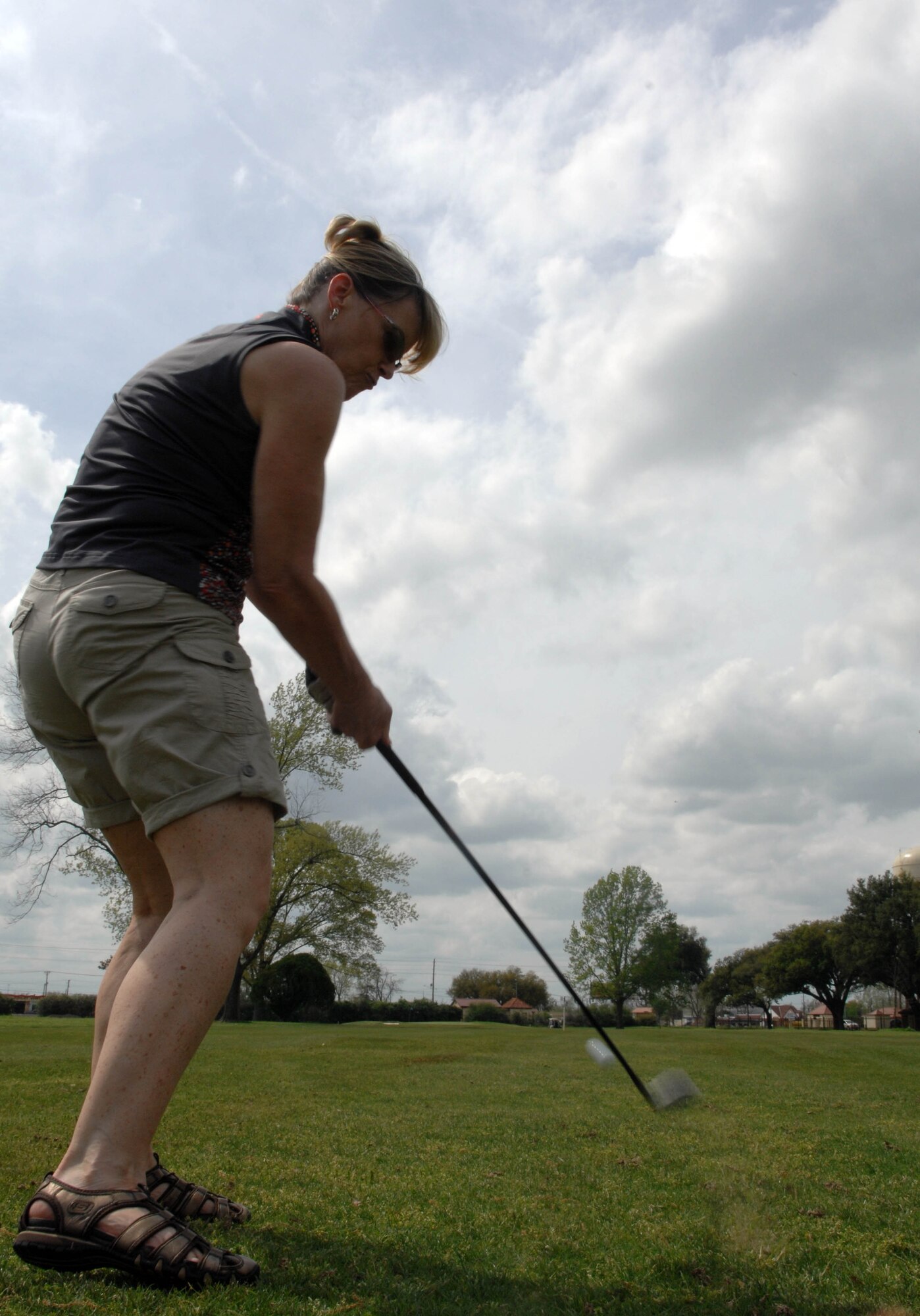 Kye Quesinberry, wife of Lt. Col. Milo Quesinberry, 2nd Mission Support Group, hits a golf ball at the Fox Run golf course on Barksdale Air Force Base, La. March 16. Kye Quesinberry played to help the Barksdale Officer's Spouses Club raise money for base organizations, scholarships and the off-base community. (U.S. Air Force photo/Airman 1st Class Joseph A. Pagán Jr.)(RELEASED) 