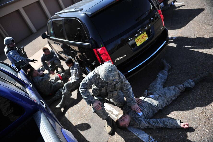 U.S. Air Force Staff Sgt. David Yawn, 27th Special Operations Security Forces Squadron, applies pressure to a simulated wound using an identification badge during an active shooter training scenario at Cannon Air Force Base, N.M., March 1, 2012. Training scenarios provide a safe and controlled environment to practice different tactics, techniques and procedures. (U.S. Air Force photo by Tech. Sgt. Josef Cole)