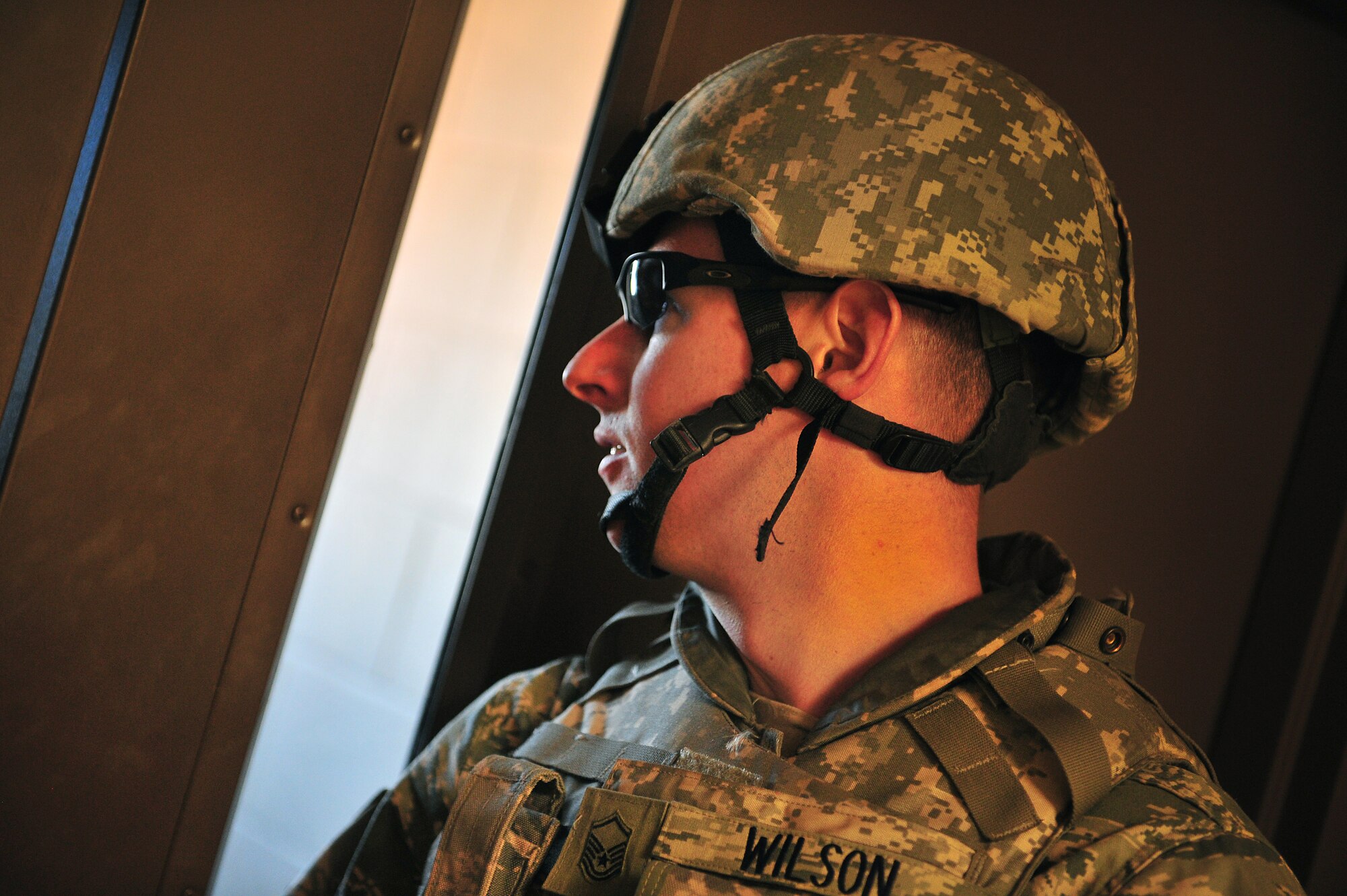 U.S. Air Force Master Sgt. Robert Wilson, 27th Special Operations Security Forces Squadron, checks for activity oustide during an active shooter training scenario at Cannon Air Force Base, N.M., March 1, 2012. Training scenarios provide a safe and controlled environment to practice different tactics, techniques and procedures. (U.S. Air Force photo by Tech. Sgt. Josef Cole)