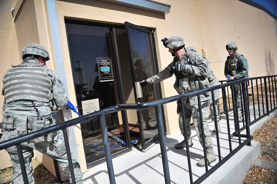 U.S. Air Force Airmen from the 27th Special Operations Security Forces Squadron, move in to clear a building during an active shooter training scenario at Cannon Air Force Base, N.M., March 1, 2012. Training scenarios provide a safe and controlled environment to practice different tactics, techniques and procedures. (U.S. Air Force photo by Tech. Sgt. Josef Cole)