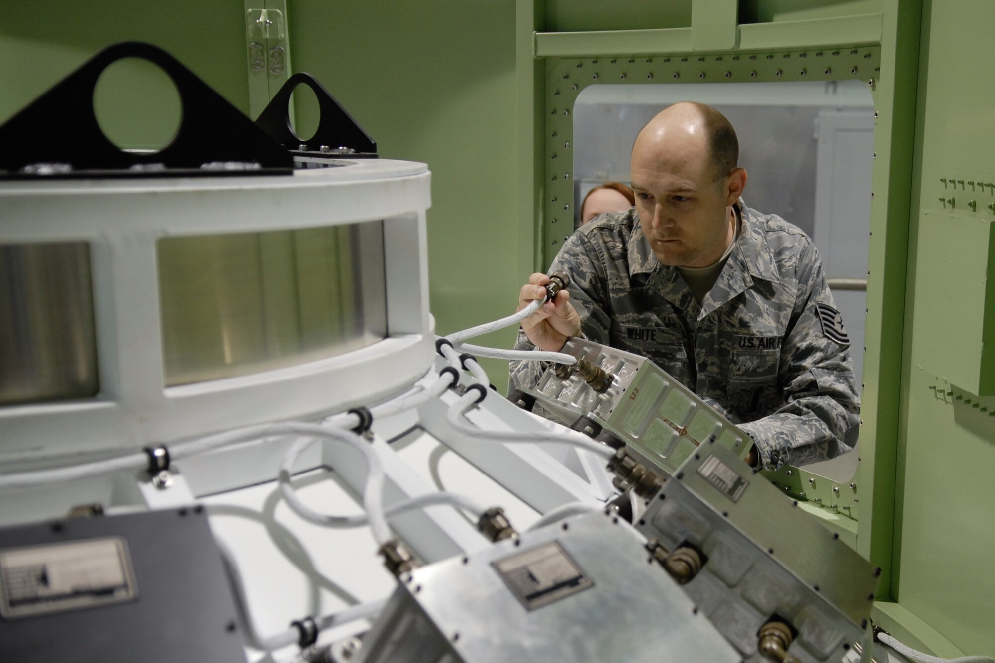VANDENBERG AIR FORCE BASE, Calif. – Tech. Sgt. Jerrid White, 4th Space Launch Squadron mission assurance technician, examines the trainer here Thursday, March 8, 2012. The squadron’s new training facility, Bogart Bay, will see its first class in June. (U.S. Air Force photo/ Jennifer Green-Lanchoney)