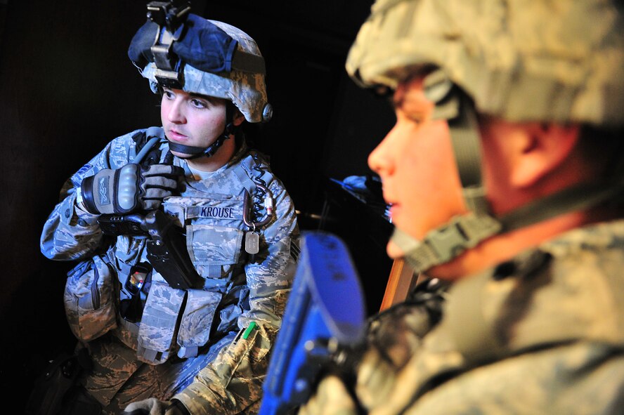 U.S. Air Force Senior Airman Micheal Krouse, 27th Special Operations Security Forces Squadron, communicates with his team during an active shooter training scenario at Cannon Air Force Base, N.M., March 1, 2012. Training scenarios provide a safe and controlled environment to practice different tactics, techniques and procedures. (U.S. Air Force photo by Tech. Sgt. Josef Cole)