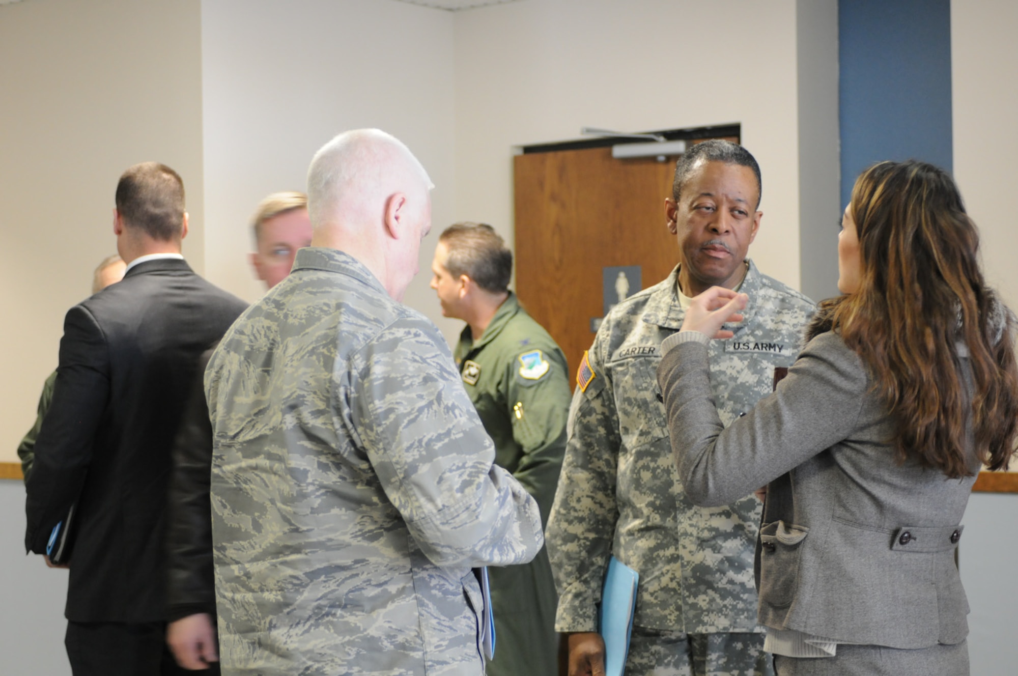 Maj. Gen. Joseph C. Carter, The Adjutant General of the Massachusetts National Guard, speaks with a legislative director to U.S. Rep. William Keating, D-Bourne, during his visit to Otis Air National Guard Base, Mass., March 16. Carter was among a group of local state and federal legislative leaders who received a status update on the wing and its future objectives as well as a tour of the 102nd Air Operations Group and a Joint Incident Site Communications Capability (JISCC) facility here. (National Guard photo by Tech. Sgt. Kerri Cole/Released)