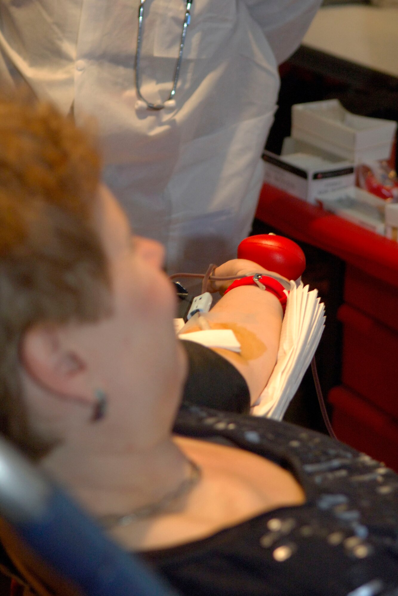 Sheila Terrando, Air Force Network Integration Center mail clerk, donates her 100th pint of blood March 13, 2012, at Scott Air Force Base, Ill. Every pint of blood that is donated can save up to three lives. (U.S. Air Force photo/Airman 1st Class Jake Eckhardt)