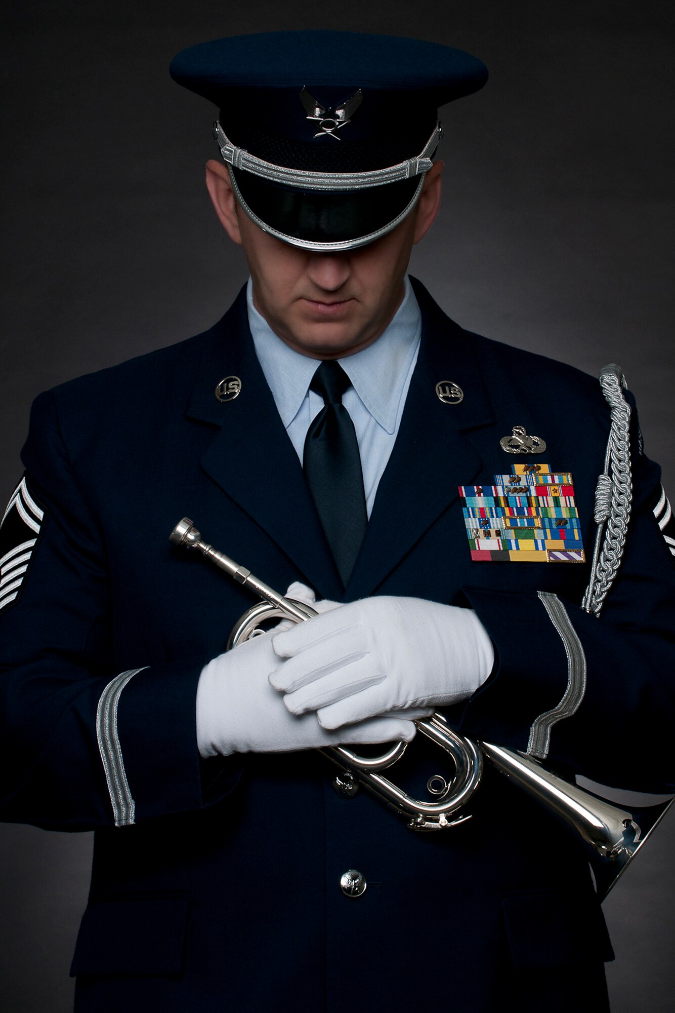 Senior Master Sgt Todd Kirkwood, 167th Airlift Wing avionics supervisor and base honor guard member, recently stepped up to play Taps at a funeral when the electronic device in the Ceremonial Bugle being used by the civilian color guard team failed to sound. Kirkwood and one other member of the unit's honor guard were tasked to fold the flag and present it to the family, but when the bugle failed Kirkwood was able to remove the electronic device from the instrument and sound Taps, which he only recently learned to play. (U.S. Air Force photo by Master Sgt. Emily Bieghtol-Deyerle)