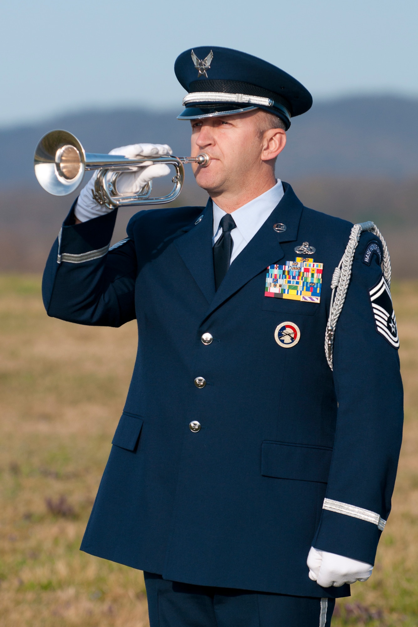 Senior Master Sgt Todd Kirkwood, 167th Airlift Wing avionics supervisor and base honor guard member, recently stepped up to play Taps at a funeral when the electronic device in the Ceremonial Bugle being used by the civilian color guard team failed to sound. Kirkwood and one other member of the unit's honor guard were tasked to fold the flag and present it to the family, but when the bugle failed Kirkwood was able to remove the electronic device from the instrument and sound Taps, which he only recently learned to play. (U.S. Air Force photo by Master Sgt. Emily Beightol-Deyerle)