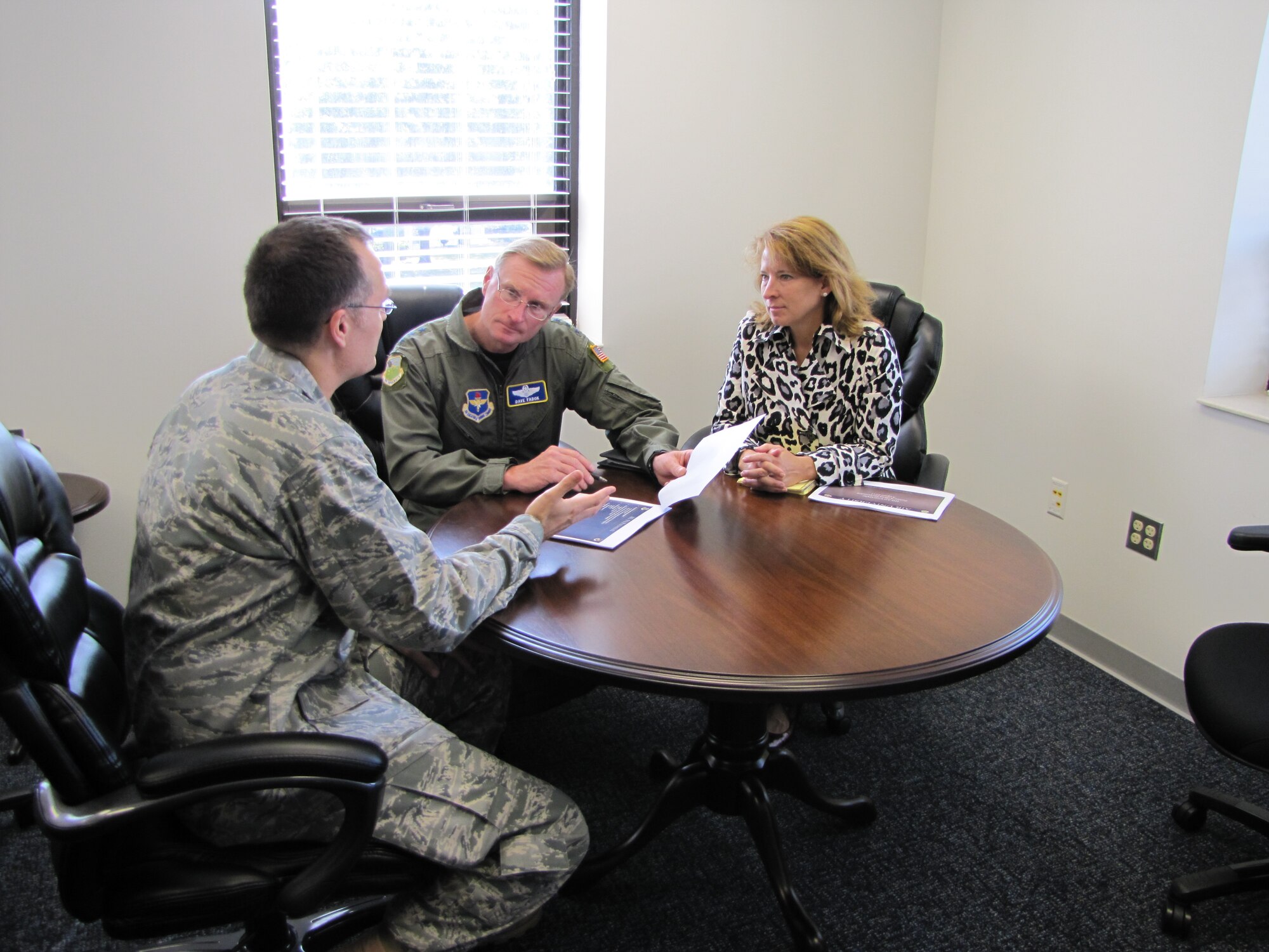 Kathleen Fadok, right, accompanies Maj. Gen. David Fadok, center, commander and president of the Air University, as he receives a briefing from Maj. John Redfield, director of Air University Public Affairs in this August 2011 photo. (Air Force photo/Jessica Casserly)