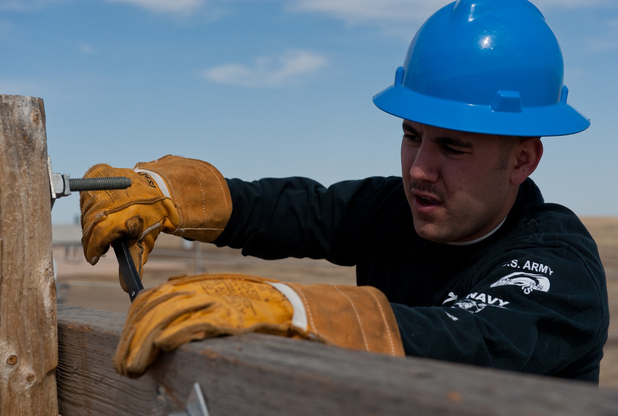 Airman 1st Class Alex Price, 28th Civil Engineer Squadron electric lineman, installs a cross-section onto a new utility pole during an equipment upgrade at the base Electric Shop’s training site on Ellsworth Air Force Base, S.D., March 13, 2012. The de-energized site allows 28th CES Airmen to safely train on electrical equipment. (U.S. Air Force photo by Airman 1st Class Kate Thornton/Released)