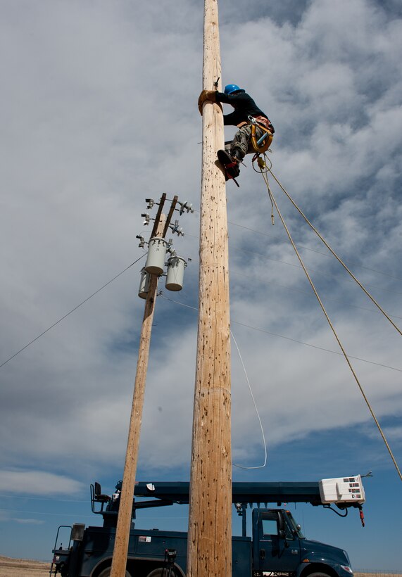Airman 1st Class Alex Price, 28th Civil Engineer Squadron electric lineman, climbs a new utility pole to begin equipment upgrades at the base Electric Shop’s training site on Ellsworth Air Force Base, S.D., March 13, 2012. Airmen from the 28th CES must physically climb the poles unreachable by other means to ensure equipment serviceability. (U.S. Air Force photo by Airman 1st Class Kate Thornton/Released)