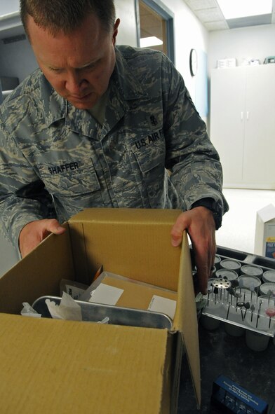 Master Sgt. Denny Shaffer, 2nd Dental Squadron dental lab flight chief, checks the contents of a box in the dental lab on Barksdale Air Force Base, La., March 13. Airmen from the dental lab had to move their equipment due to renovations being made to the lab. (U.S. Air Force photo/Airman 1st Class Micaiah Anthony)(RELEASED)