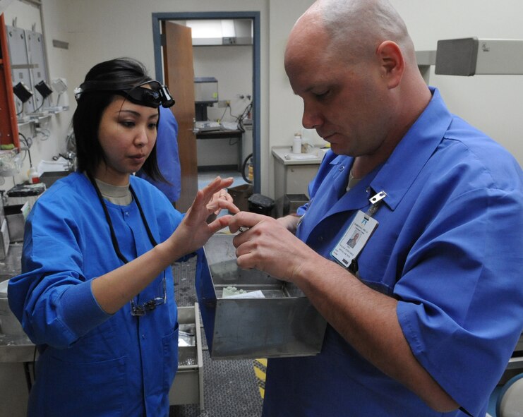 Capt. Arlene Esche, 2nd Dental Squadron dentist, gives Tech. Sgt. William Fitzpatrick, 2 DS lab craftsman, a patient's prescription in the dental lab on Barksdale Air Force Base, La., March 13. The dental lab will be undergoing renovations over the next eight weeks. Airmen in the lab will be working in alternate locations around the dental clinic to continue supporting the Barksdale community. (U.S. Air Force photo/Airman 1st Class Micaiah Anthony)(RELEASED)
