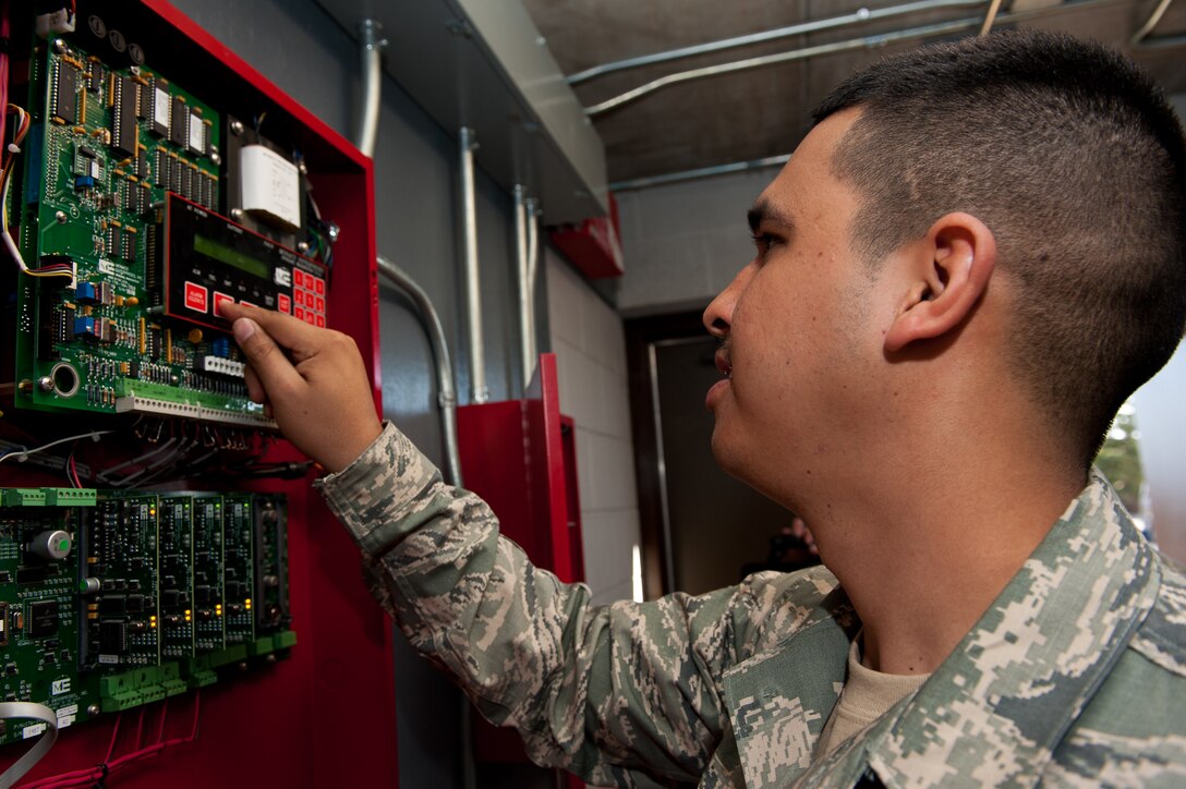 Senior Airman Alan Rosales, 28th Civil Engineer Squadron electrician journeyman, initiates the walk-test feature on the fire alarm system at the Jefferson dormitory during an annual inspection on Ellsworth Air Force Base, S.D., March 13, 2012. This feature saves time and manpower by allowing electricians to test the accuracy of each fire alarm pull station throughout the dormitory in one centralized location. (U.S. Air Force photo by Airman 1st Class Kate Thornton/Released)