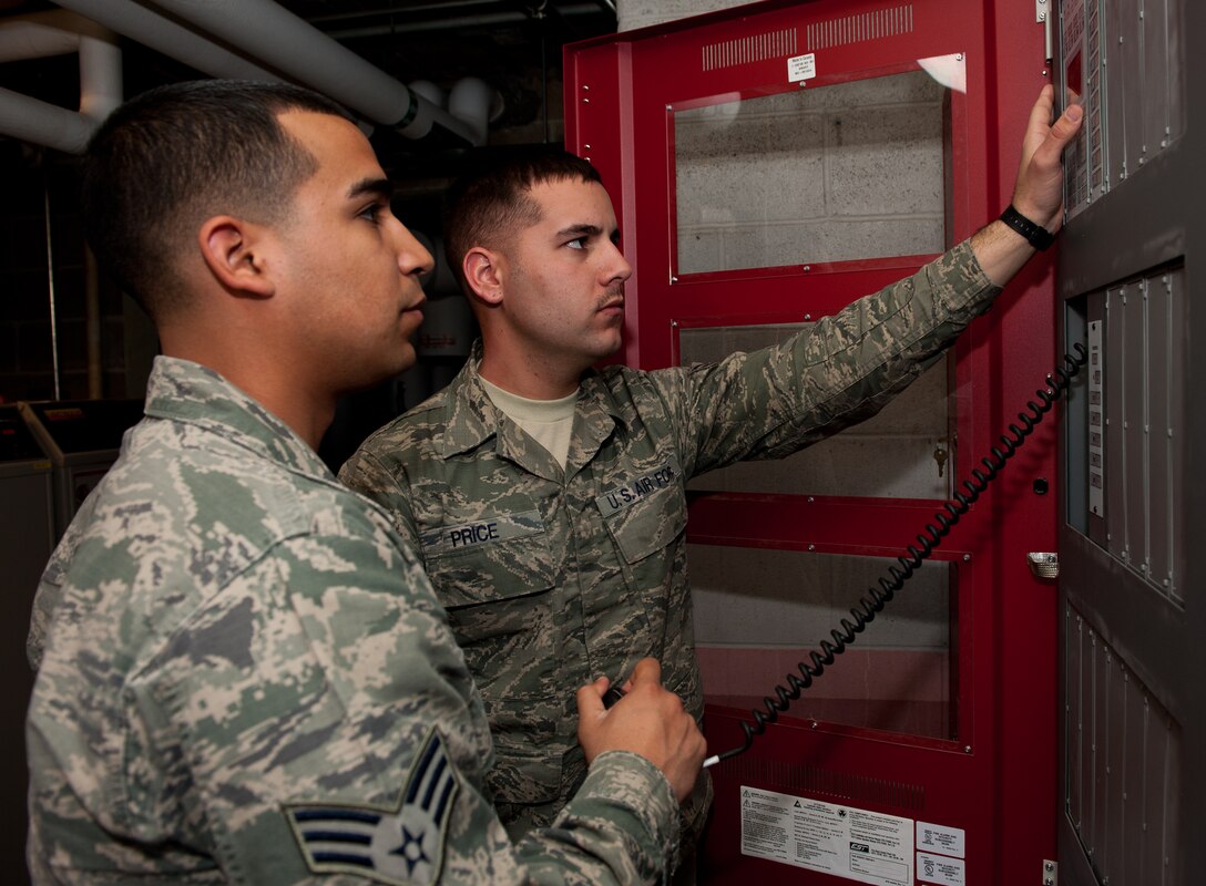 Senior Airman Daniel Cordova, left, and Airman 1st Class Alex Price, 28th Civil Engineer Squadron electrician journeymen, test the mass notification system during an annual inspection at the Jefferson dormitory on Ellsworth Air Force Base, S.D., March 13, 2012. The system automatically notifies both dormitory residents and the base Fire Department in the event of an emergency. (U.S. Air Force photo by Airman 1st Class Kate Thornton/Released)