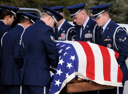 Airmen with the Air Force Academy Honor Guard move the body of Capt. Ryan Hall into a vehicle for transportation from the Cadet Chapel to the Academy Cemetery March 12, 2012. Hall was the son of 1970 Academy graduate Dennis Hall and his wife, Kliffa. (U.S. Air Force photo/Sarah Chambers)