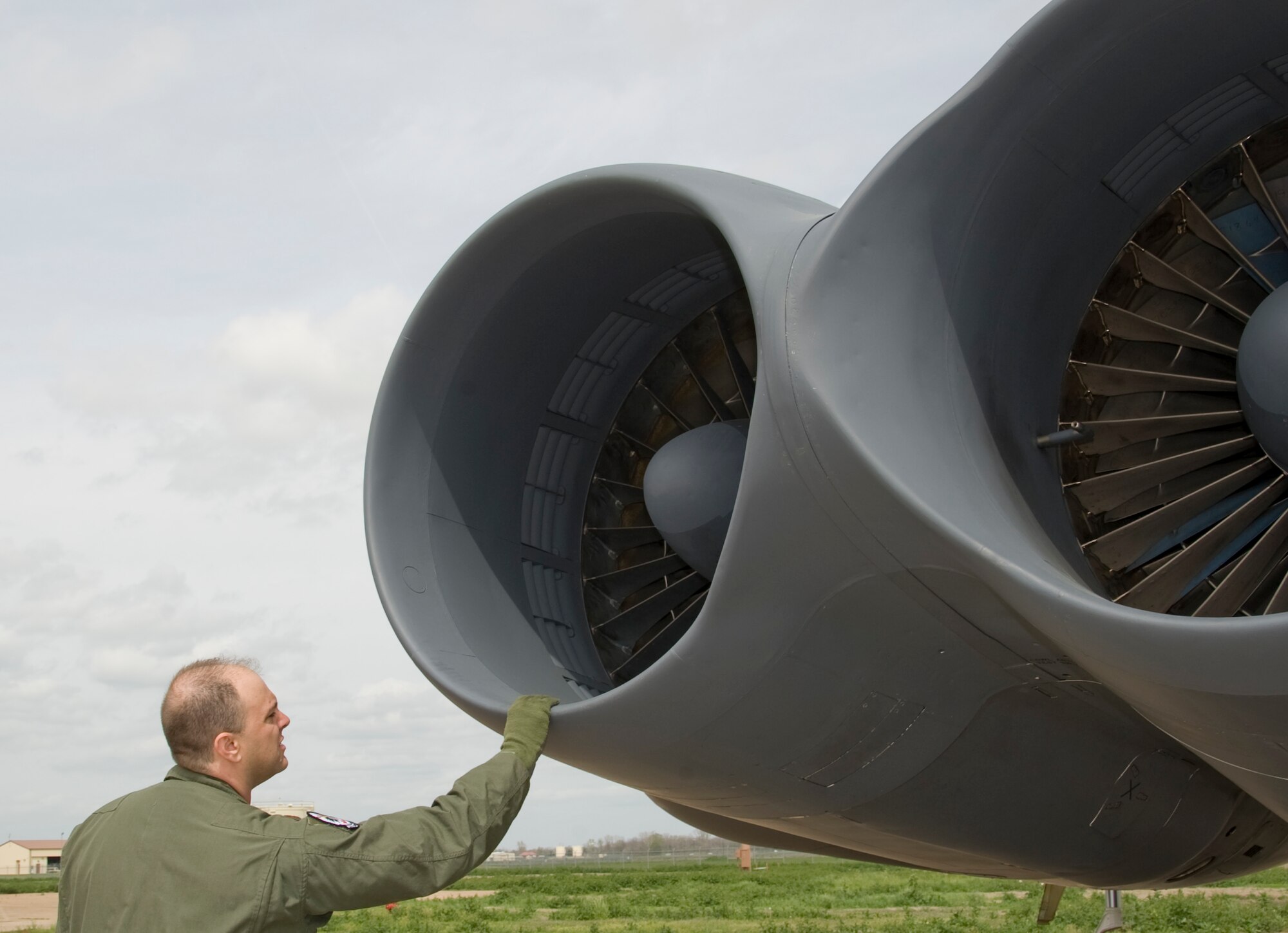 Maj. Brian Sealock, 20th Bomb Squadron, inspects an engine of a B-52H Stratofortress on Barksdale Air Force Base, La., March 13. Each member of the aircrew has his or her own specific items of interest they look at as they conduct an aircraft inspection before takeoff. (U.S. Air Force photo/Airman 1st Class Benjamin Gonsier)(RELEASED)
