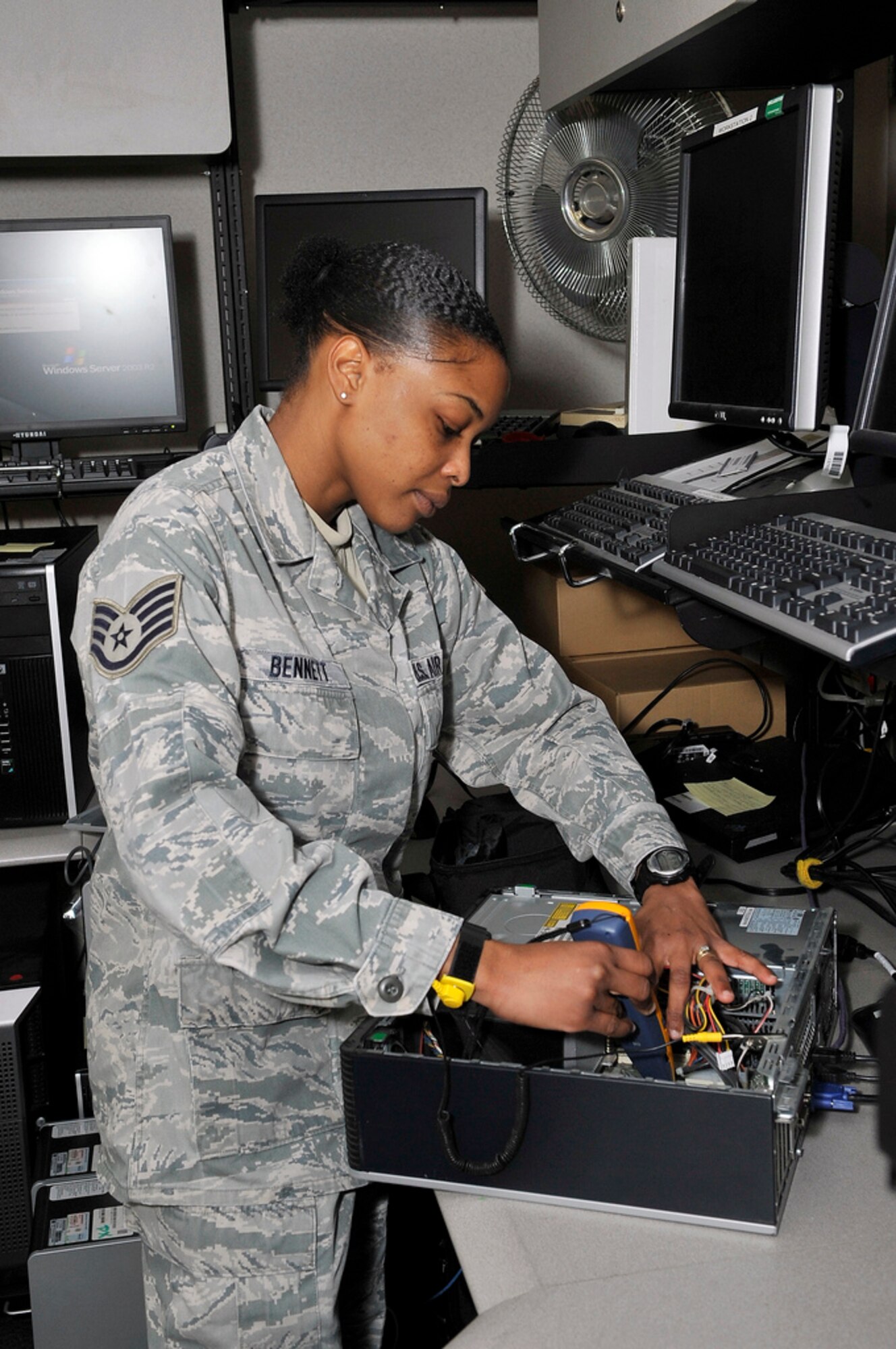 Staff Sgt. Gillian Bennett, 87th Logistics Readiness Squadron system management specialist, born in Kingston, Jamaica, who calls Palm Beach, Fla. home, repairs computers for the squadron and also volunteers as a motivator for the squadron "Reconditioning Program," which is a volunteer physical training "Boot Camp." (U.S. Air Force photo by Wayne Russell/Released)