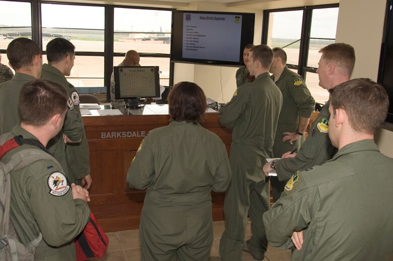 Aircrew members from the 20th Bomb Squadron receive a weather briefing before their flight on Barksdale Air Force Base, La., March 13. The aircrew adjusts their flight plans depending on the kind of weather in the area. (U.S. Air Force photo/Airman 1st Class Benjamin Gonsier)(RELEASED)