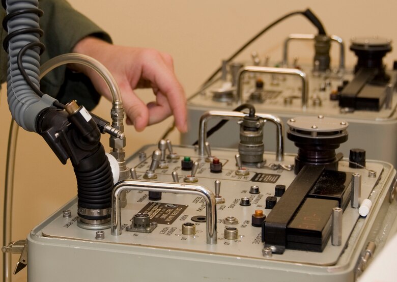 An aircrew member from the 20th Bomb Squadron uses a scot tester on Barksdale Air Force Base, La., March 13. Aircrew members connect their flight equipment to the scot tester to check for a good seal, oxygen leaks and to make sure the intercom system inside the helmets work. (U.S. Air Force photo/Airman 1st Class Benjamin Gonsier)(RELEASED)