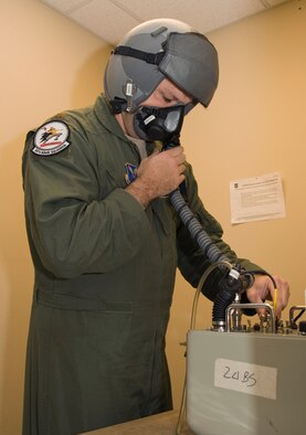Maj. Brian Sealock, 20th Bomb Squadron, checks the seal on his flight equipment on Barksdale Air Force Base, La., March 13. Aircrew check the seals on their masks to make sure there are no oxygen leaks. A broken seal would make it hard for aircrew members to receive oxygen during an emergency. (U.S. Air Force photo/Airman 1st Class Benjamin Gonsier)(RELEASED)
