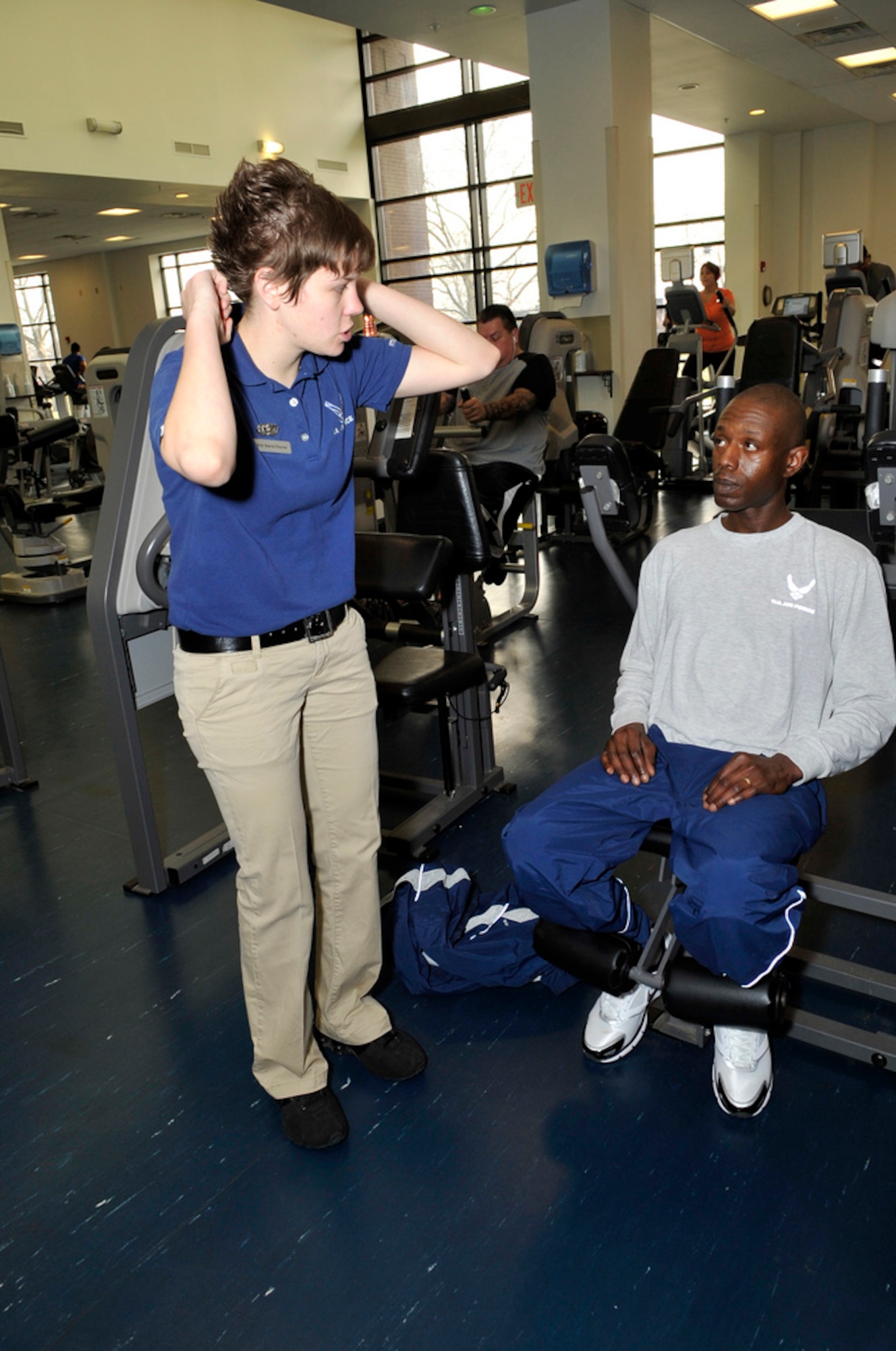 Senior Airman Sierra Thorne, 87th Force Support Squadron fitness specialist from Larned, Kan., explains proper techniques and benefits of workout equipment March 13 with Tech. Sgt. Christian Boswell, 87th Logistics Readiness Squadron assistant NCO in charge of individual protective equipment, originally from Baltimore, Md. (U.S. Air Force photo by Wayne Russell/Released)
