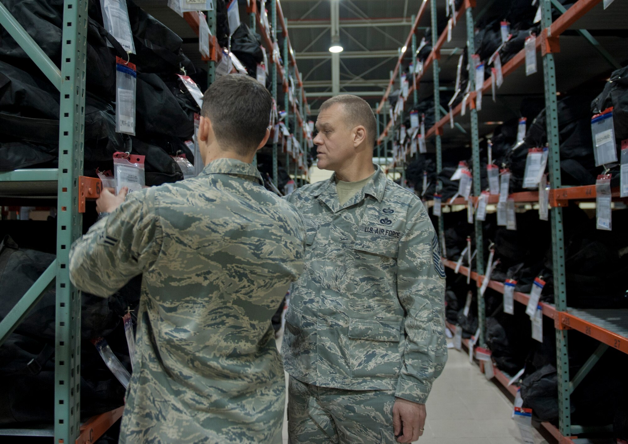 Airman 1st Class Brendan Broussard, 39th Logistics Readiness Squadron, left, shows Chief Master Sgt. of the Air Force James Roy, right, chemical, biological, radiological and nuclear protection gear March 16, 2012, at Incirlik Air Base, Turkey. Roy and Broussard discussed the process involved with ensuring all members of Incirlik receive CBRNE protection gear. (U.S. Air Force photo by Senior Airman Anthony Sanchelli/Released)
