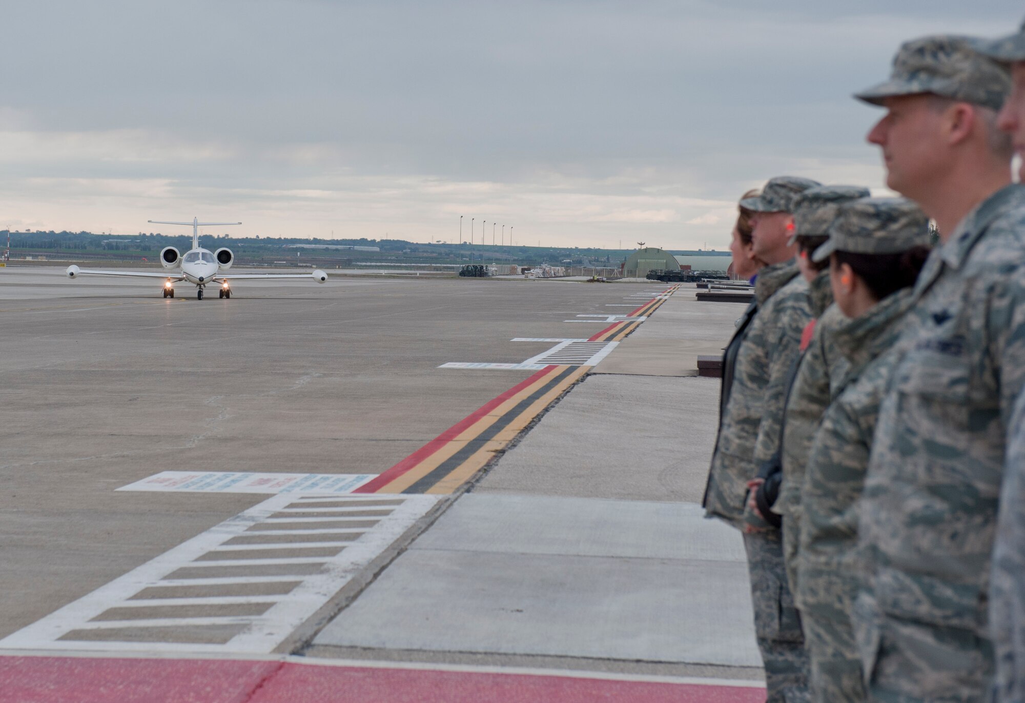 Members of Team Incirlik stand near the flightline awaiting the arrival of Chief Master Sgt. of the Air Force James Roy March 15, 2012, at Incirlik Air Base, Turkey. Roy visited to meet with Airmen and discuss unit morale, wellness and mission capabilities. (U.S. Air Force photo by Senior Airman Anthony Sanchelli/Released)