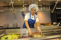 Diana Bailey, 902nd Force Support Squadron Dining Facility salad technician, stocks the salad bar in preparation for lunch time at the Joint Base San Antonio-Randolph Dining Facility here March 9, 2012. (U.S. Air Force photo by Rich McFadden) (released)