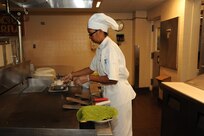Florencia Miranda, 902nd Force Support Squadron Dining Facility grill cook, prepares to make chicken wraps in preparation for lunch time at the Joint Base San Antonio-Randolph Dining Facility here March 9, 2012. (U.S. Air Force photo by Rich McFadden) (released)