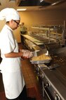 Florencia Miranda, 902nd Force Support Squadron Dining Facility grill cook, prepares fried brown rice in preparation for lunch time at the Joint Base San Antonio-Randolph Dining Facility here March 9, 2012. (U.S. Air Force photo by Rich McFadden) (released)