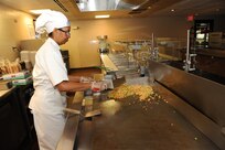 Florencia Miranda, 902nd Force Support Squadron Dining Facility grill cook, prepares fried brown rice in preparation for lunch time at the Joint Base San Antonio-Randolph Dining Facility here March 9, 2012. (U.S. Air Force photo by Rich McFadden) (released)