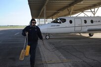 Robert Riojas, 12th Flying Traing Wing Maintenance Division, pulls the chalks prior to the launch of a T-1 Jayhawk aircraft from the 99th Flying Training Squadron on Joint Base San Antonio-Randolph March 6, 2012. The 99th FTS is an important part of the Pilot Instructor Training program at JBSA-Randolph. (U.S. Air Force photo by Rich McFadden) (released)