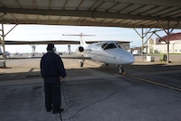 Robert Riojas, 12th Flying Traing Wing Maintenance Division, watches as the pilot starts the engines of a T-1 Jayhawk aircraft from the 99th Flying Training Squadron on Joint Base San Antonio-Randolph March 6, 2012. The 99th FTS is an important part of the Pilot Instructor Training program at JBSA-Randolph. (U.S. Air Force photo by Rich McFadden) (released)