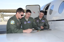 (from right to left) Lt. Col. James Drake, Maj. Kevin Kotula and 1st Lt. Casey Eikhold, 99th Flying Training Squadron, run through a checklist prior to the launch of a T-1 Jayhawk aircraft on Joint Base San Antonio-Randolph, Texas March 6. The 99th FTS is an important part of the Pilot Instructor Training program at JBSA-Randolph. (U.S. Air Force photo by Rich McFadden) (released)