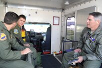(Right to left) Lt. Col. James Drake, 1st Lt. Casey Eikhold and Maj. Kevin Kotula, 99th Flying Training Squadron, take the crew bus out to their T-1 Jayhawk aircraft for an early morning mission on Joint Base San Antonio-Randolph, Texas March 6. The 99th FTS is an important part of the Pilot Instructor Training program at JBSA-Randolph. (U.S. Air Force photo by Rich McFadden) (released)