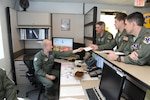 Lt. Col. Richard Stoffel, 99th Flying Training Squadron operations desk, performs a final operational readiness check for (from left to right) Lt. Col. James Drake,1st Lt. Casey Eikhold and  Maj. Kevin Kotula, 99th Flying Training Squadron, prior an early morning mission on a T-1 Jayhawk aircraft on Joint Base San Antonio-Randolph, Texas March 6. The 99th FTS is an important part of the Pilot Instructor Training program at JBSA-Randolph. (U.S. Air Force photo by Rich McFadden) (released)