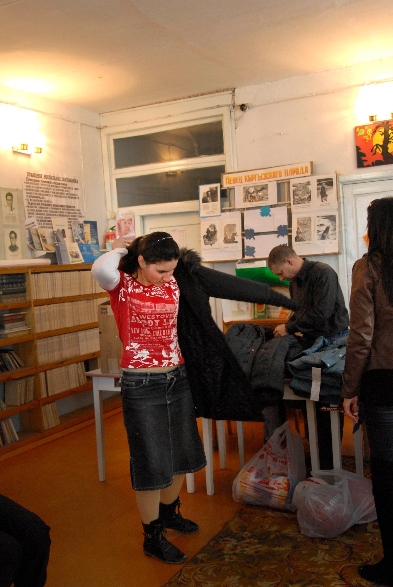 Salieva Veronika, a 10th grader at Jany Pahkta School in Bishkek, Kyrgyzstan, tries on a jacket March 15, 2012. Airmen from the 376th Expeditionary Force Support Squadron at the Transit Center at Manas visit the school once a month to donate school supplies and other items. (U.S. Air Force photo/Senior Airman Lynsie Nichols)