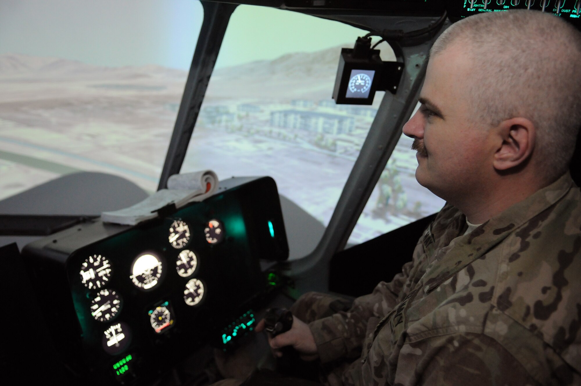 U.S. Navy Petty Officer 1st Class Robert Hay, 438th Air Expeditionary Wing Thunder Lab leadership and professionalism director, experiences the collective, side-click, and rotary pedal functions of an Afghan air force Mi-17 helicopter simulator during a familiarization training session, Kabul International Airport, Afghanistan, March 15, 2012. Hay received a crash course in aviation prior to the move of Thunder Lab to Shindand Air Base, Afghanistan, to aid in instructing Afghan pilot candidates through approximately 60 hours of academic instruction as well as flight screening in the Cessna 182T prior to beginning flight training. (U.S. Air Force photo by Staff Sgt. Nadine Y. Barclay)