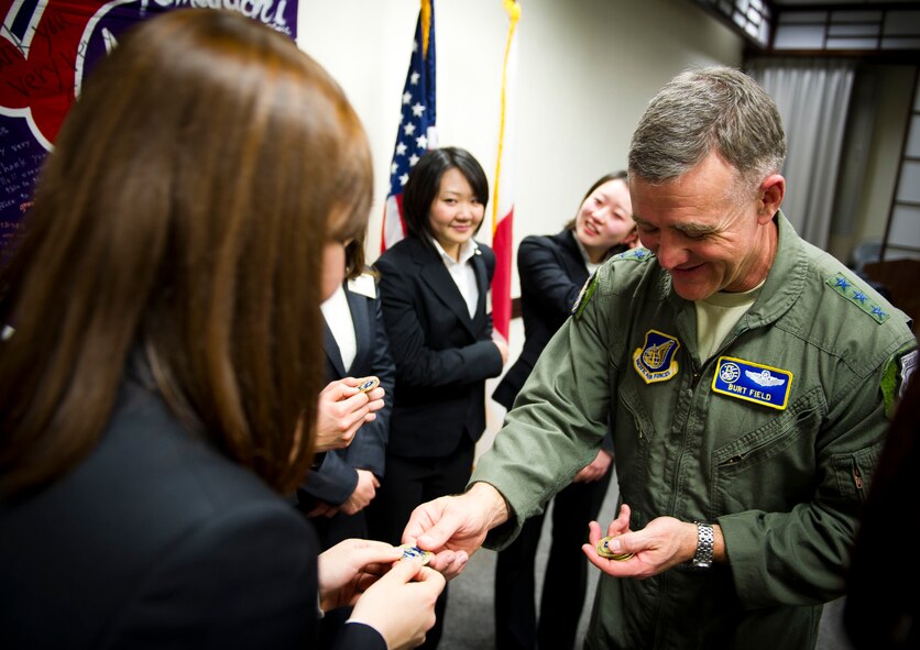 YOKOTA AIR BASE, Japan -- Lt. Gen. Burton Field, United States Forces Japan commander and 5th Air Force commander, presents the students with his coin symbolizing a token of his thanks and friendship March 16, 2012. Prior to the ceremony, the students received a tour of the base and a C-130 Hercules, an aircraft that played a vital role during the recovery effort after the tsunami. (U.S. Air Force photo/Staff Sgt. Chad C. Strohmeyer)