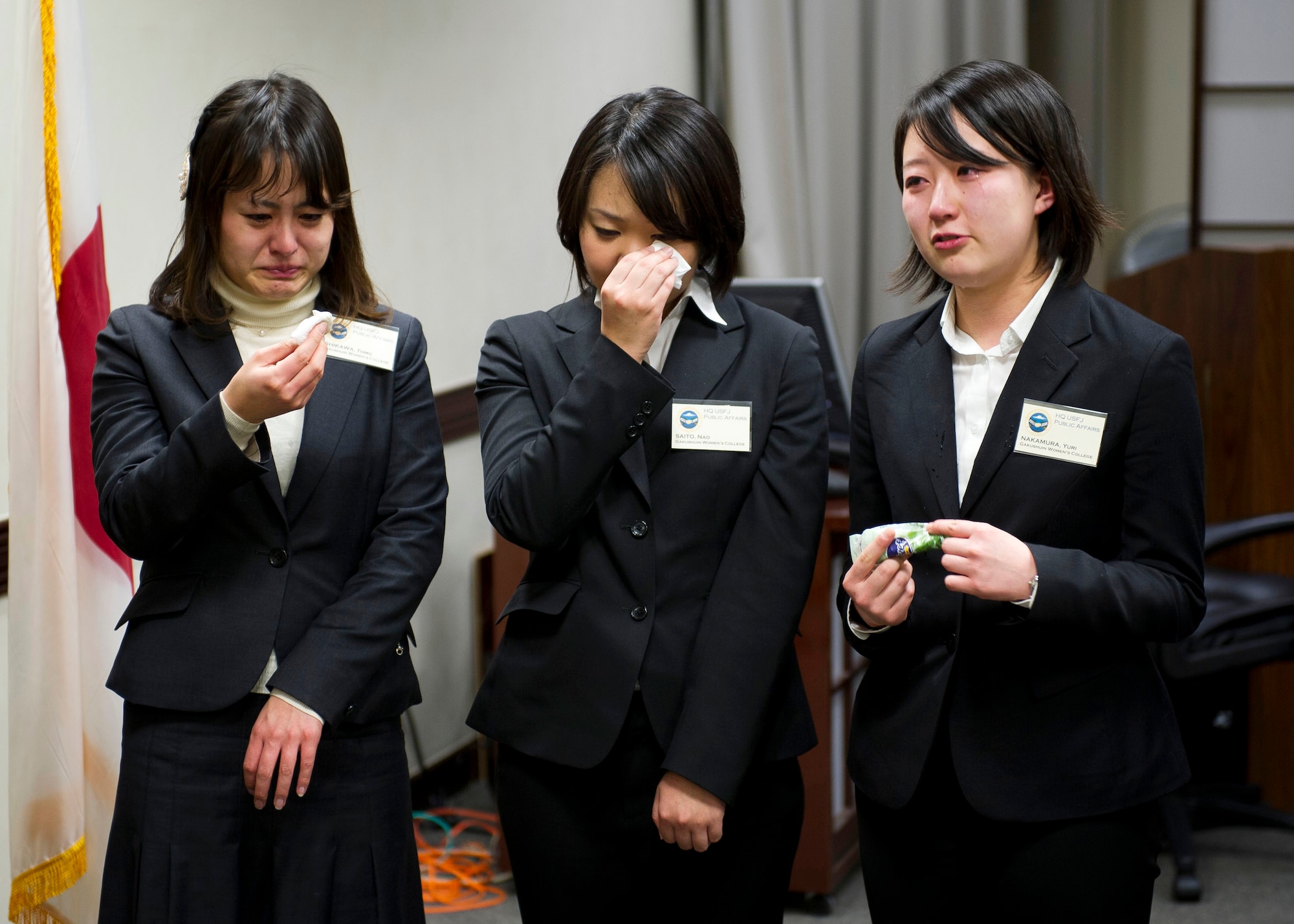 YOKOTA AIR BASE, Japan -- Tomo Ishikawa, Nao Saito and Yuri Nakamura, Gakushuin Women's College students, shed some tears as Lt. Gen. Burton Field, United States Forces Japan commander and 5th Air Force commander, speaks about the tragedies that followed the 2011 tsunami March 16, 2012. After receiving a tour of the base and a C-130 Hercules, the students presented leadership with 4,000 origami cranes. (U.S. Air Force photo/Staff Sgt. Chad C. Strohmeyer)